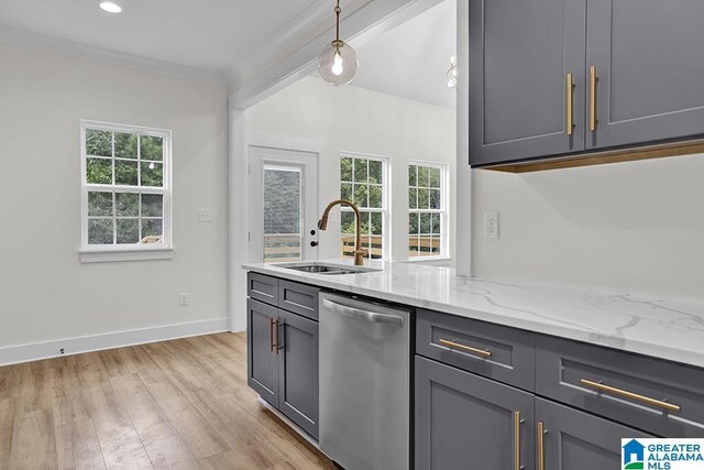 kitchen with sink, plenty of natural light, stainless steel dishwasher, and light hardwood / wood-style floors