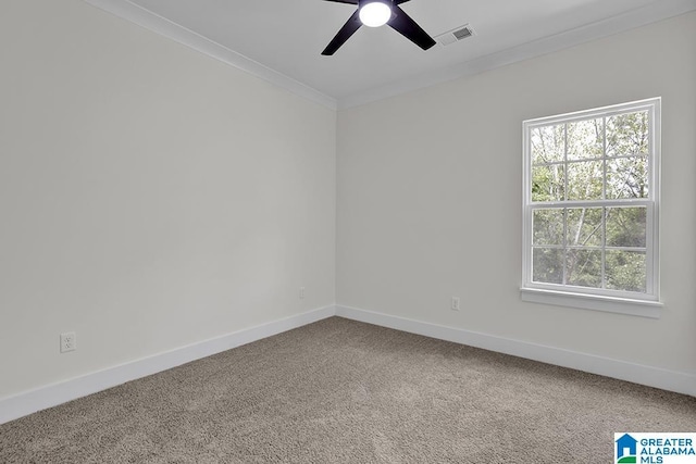 unfurnished room featuring carpet floors, ornamental molding, visible vents, and baseboards