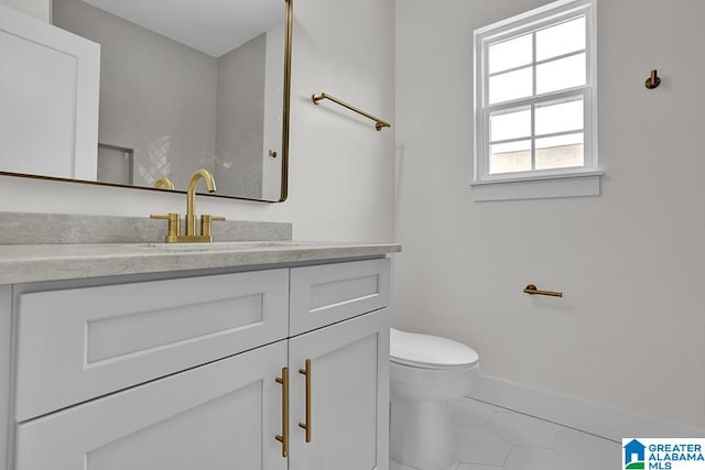 bathroom featuring tile patterned floors, toilet, and vanity