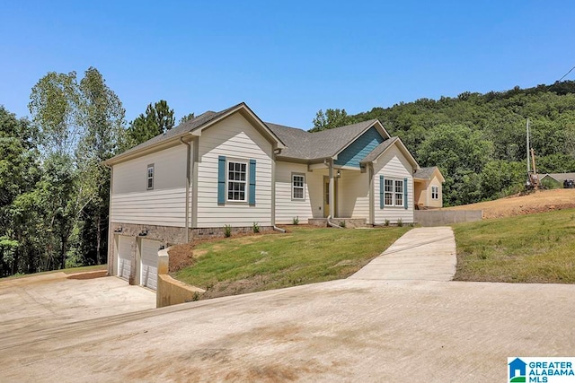 view of front of property with a garage and a front yard