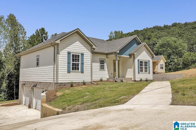 single story home featuring concrete driveway, a front lawn, an attached garage, and a shingled roof