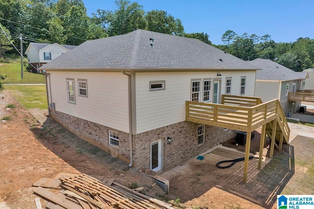 back of house featuring a deck, central AC, and a patio