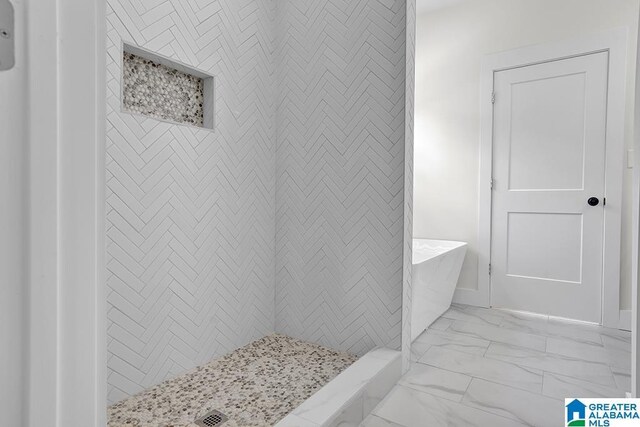 bathroom with tile patterned floors and a shower