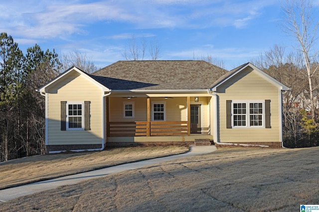 ranch-style house with a shingled roof and a porch