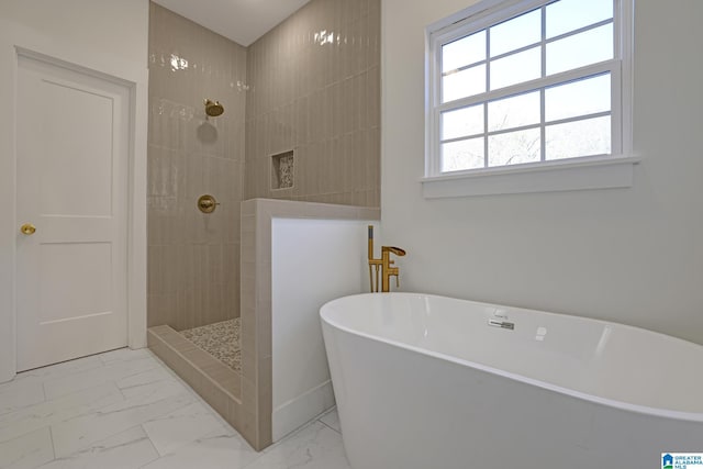 bathroom featuring separate shower and tub