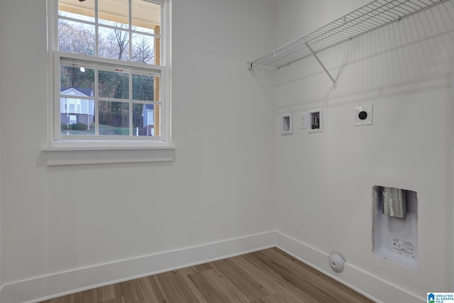 clothes washing area with hardwood / wood-style flooring, washer hookup, and electric dryer hookup