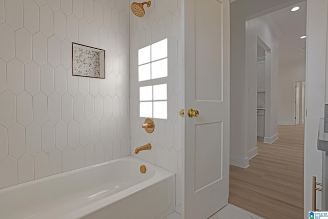 bathroom featuring hardwood / wood-style floors and shower / tub combination