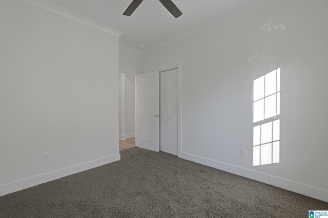 carpeted spare room with ceiling fan and ornamental molding