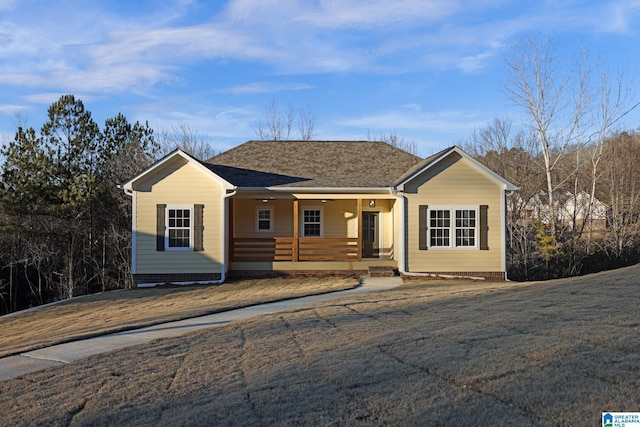 view of front of property with covered porch and a shingled roof