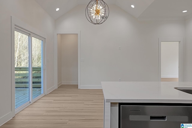 kitchen with an inviting chandelier, decorative light fixtures, vaulted ceiling, and light stone countertops