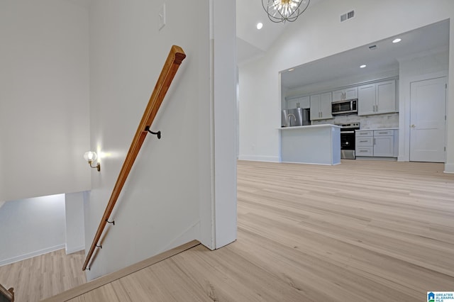 interior space with hardwood / wood-style floors and high vaulted ceiling