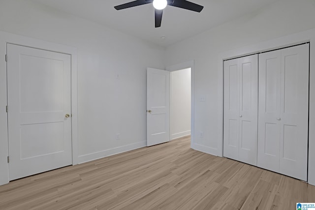 unfurnished bedroom with ceiling fan, light hardwood / wood-style floors, and a closet