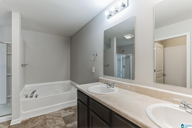 bathroom featuring tile patterned floors, separate shower and tub, and dual bowl vanity