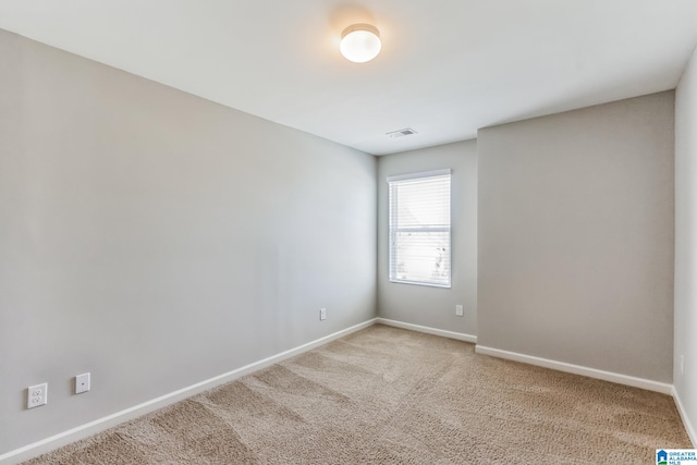 empty room featuring light carpet