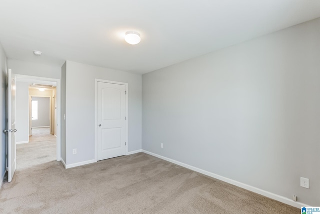 unfurnished bedroom with light colored carpet