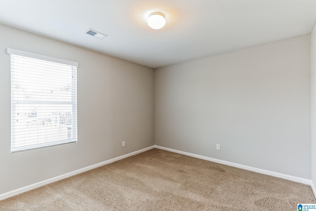 empty room featuring light carpet