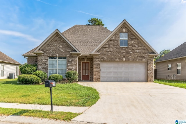 view of front of home featuring brick siding, driveway, roof with shingles, and a front lawn