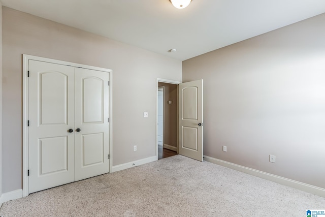 unfurnished bedroom with a closet and carpet flooring