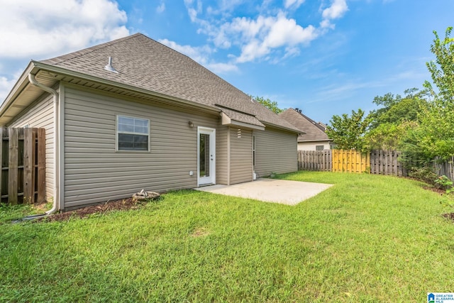 back of property featuring a patio area and a yard