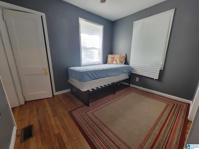 bedroom with ceiling fan and wood-type flooring