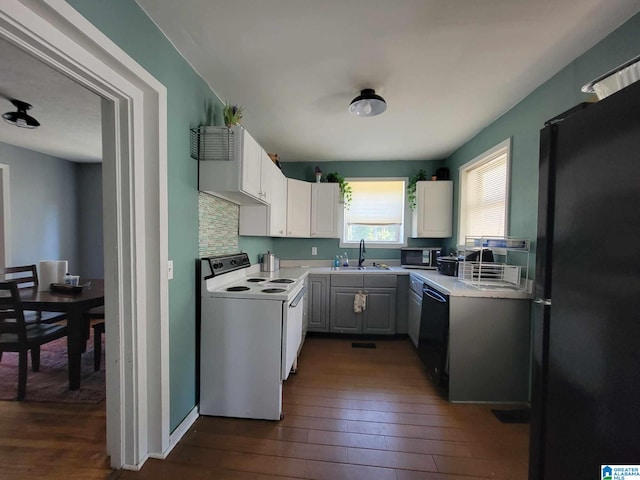 kitchen with white cabinets, sink, dark hardwood / wood-style flooring, and black appliances