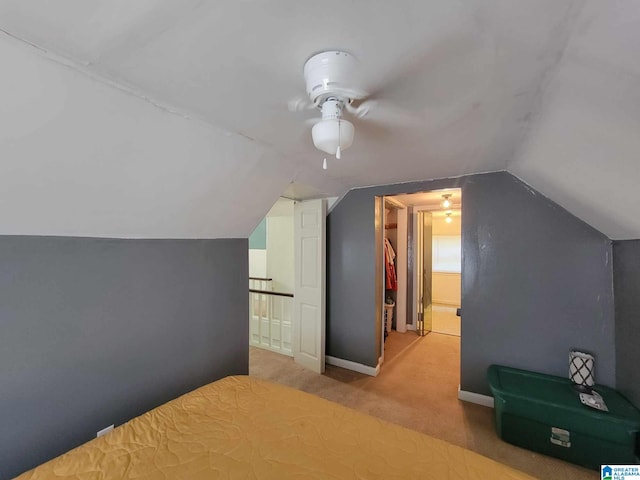 additional living space with ceiling fan, carpet floors, and lofted ceiling