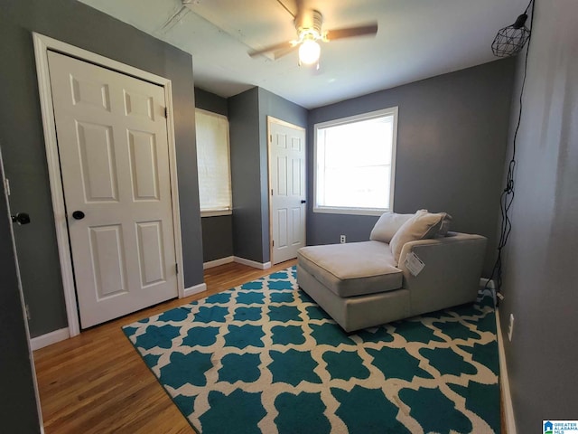 living area with hardwood / wood-style flooring and ceiling fan