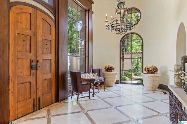 tiled entrance foyer featuring plenty of natural light and an inviting chandelier