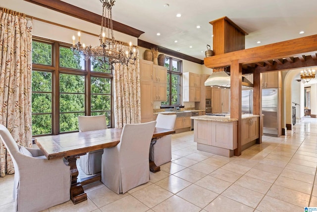 dining space with a wealth of natural light, a notable chandelier, and light tile patterned floors