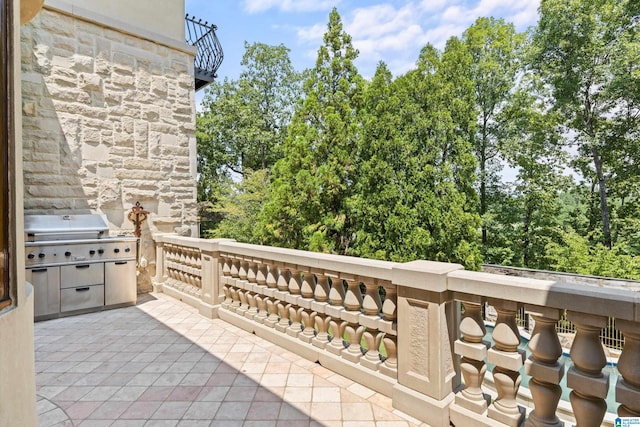 view of patio / terrace with a balcony and a grill