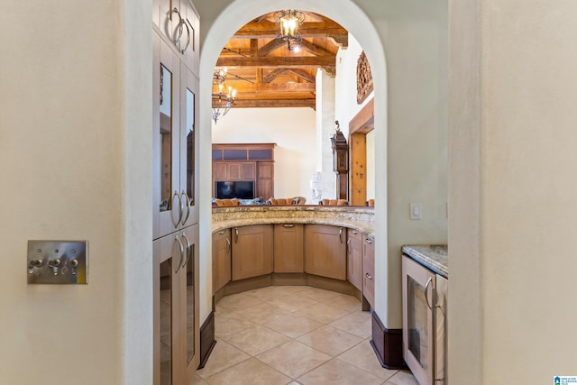 kitchen featuring beamed ceiling, beverage cooler, a chandelier, and light tile patterned floors