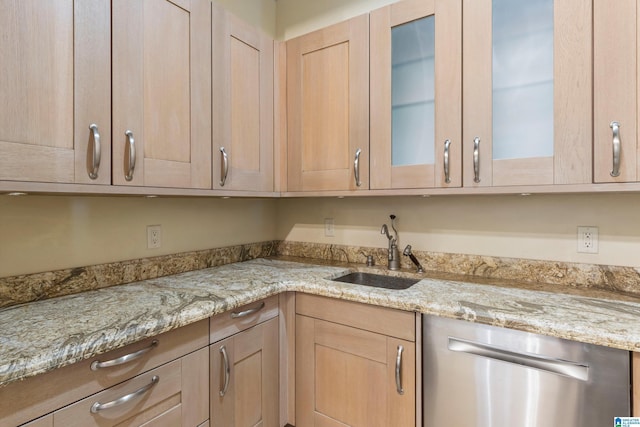 7105 Valderrama Cir, Vestavia Hills, AL 35242 - kitchen with glass insert cabinets, light brown cabinetry, light stone counters, dishwasher, and a sink