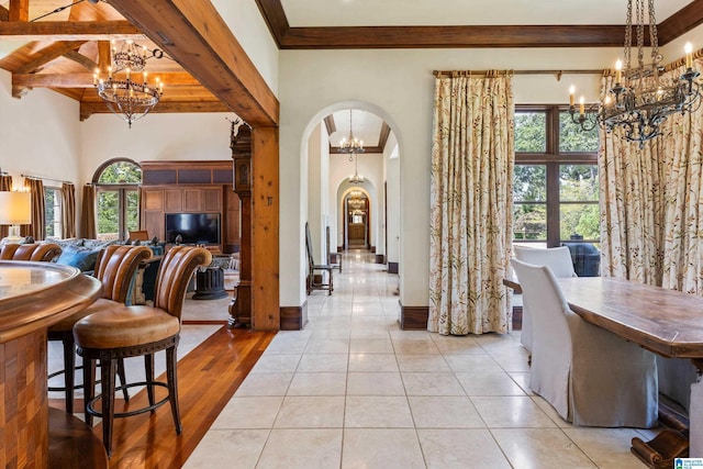 7105 Valderrama Cir, Vestavia Hills, AL 35242 - dining room featuring a chandelier, arched walkways, plenty of natural light, and beamed ceiling
