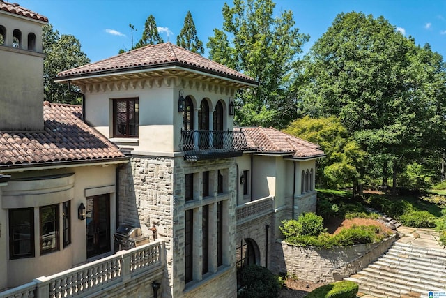 back of property with a balcony