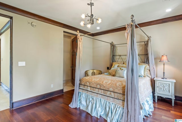 bedroom featuring dark wood-type flooring and a notable chandelier