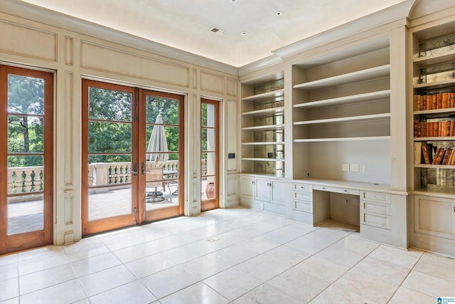 7105 Valderrama Cir, Vestavia Hills, AL 35242 - unfurnished office with visible vents, built in shelves, built in desk, french doors, and light tile patterned flooring