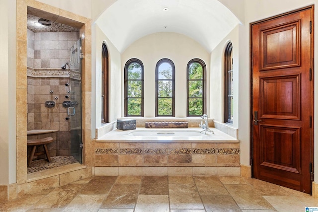 bathroom featuring vaulted ceiling, tile patterned flooring, and separate shower and tub