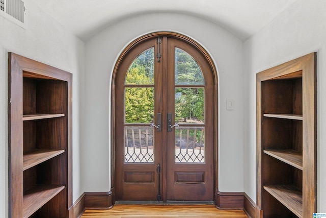 entryway with light hardwood / wood-style flooring and french doors