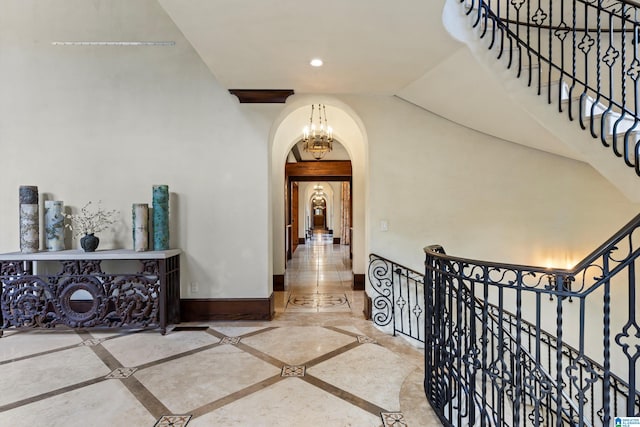 hallway featuring vaulted ceiling with beams, an inviting chandelier, and tile patterned floors