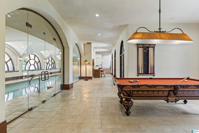 7105 Valderrama Cir, Vestavia Hills, AL 35242 - interior space featuring baseboards, billiards, recessed lighting, stone tile flooring, and arched walkways