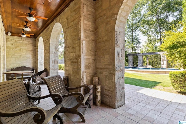 view of patio with ceiling fan, pool water feature, and outdoor lounge area