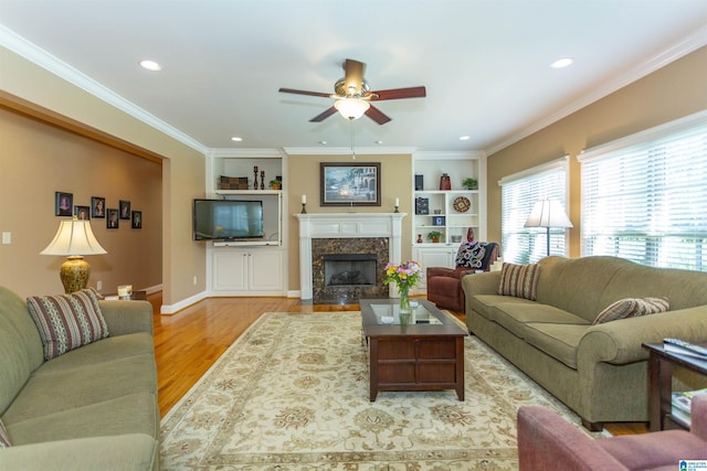 171 Sheeps Xing, Calera, AL 35040 - living room featuring a high end fireplace, ceiling fan, ornamental molding, wood finished floors, and recessed lighting