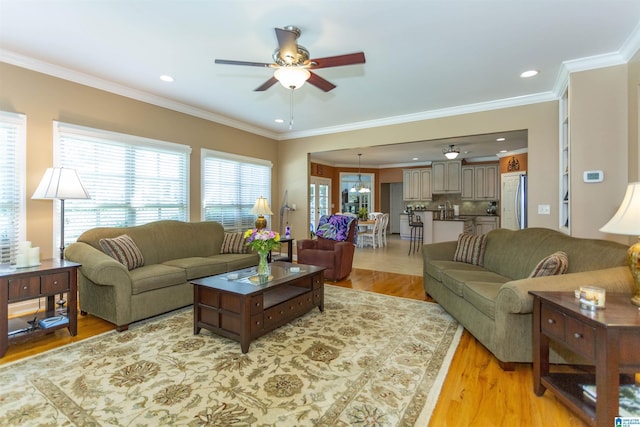 171 Sheeps Xing, Calera, AL 35040 - living room with light wood-style flooring, ornamental molding, a ceiling fan, and recessed lighting