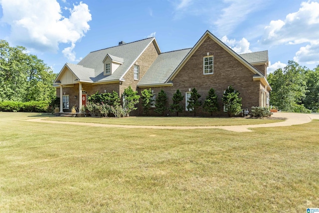 view of front of house with brick siding and a front lawn