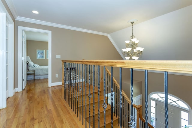 171 Sheeps Xing, Calera, AL 35040 - hall with a chandelier, ornamental molding, an upstairs landing, and light wood-style flooring