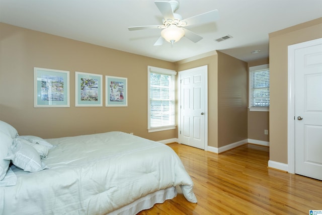 171 Sheeps Xing, Calera, AL 35040 - bedroom with light wood finished floors, a ceiling fan, visible vents, and baseboards