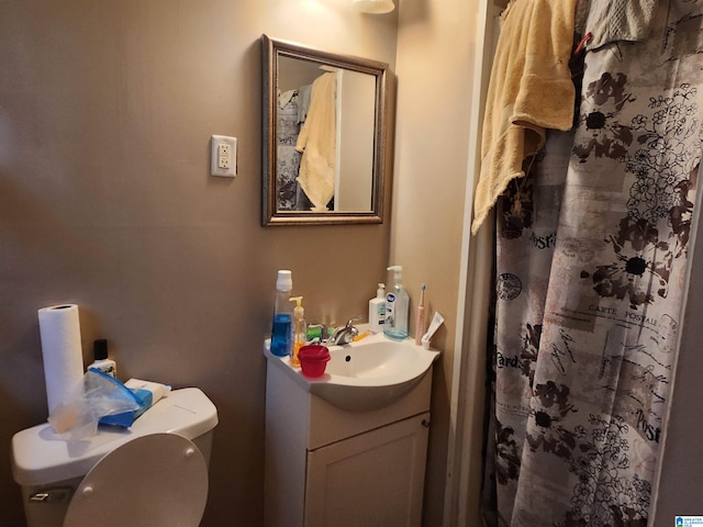 bathroom featuring toilet and vanity