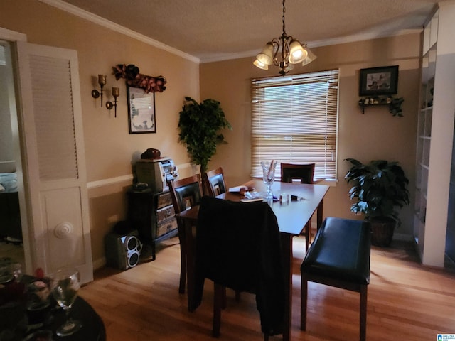 dining space with light hardwood / wood-style flooring, a chandelier, and ornamental molding