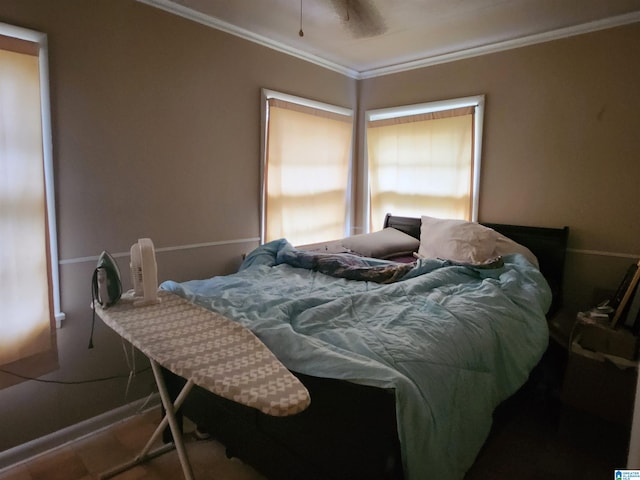 bedroom with ceiling fan and crown molding