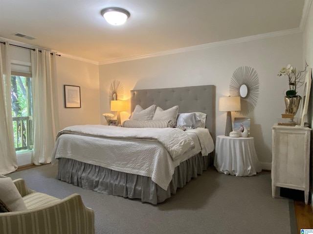 carpeted bedroom with ornamental molding